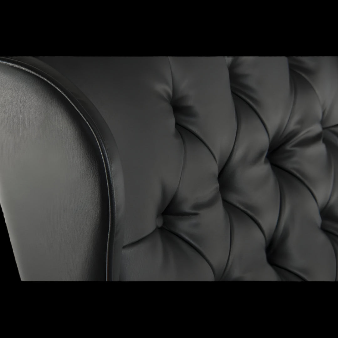 Close-up of a black tufted sofa cushion