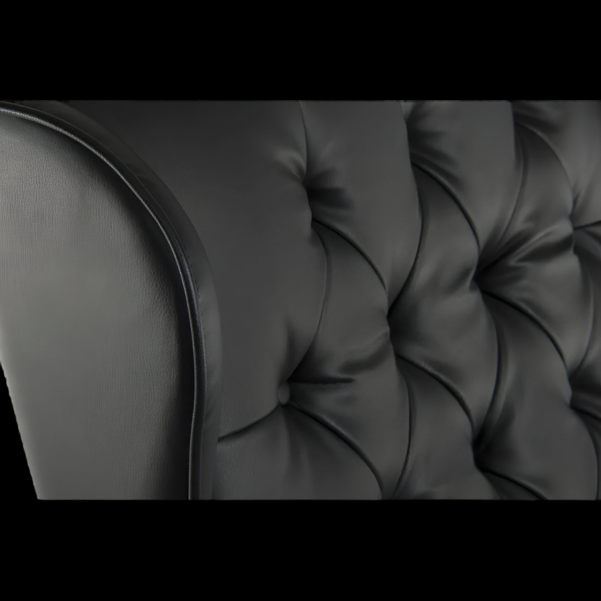 Close-up of a black tufted sofa cushion