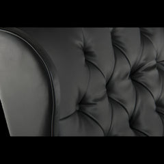 Close-up of a black tufted sofa cushion