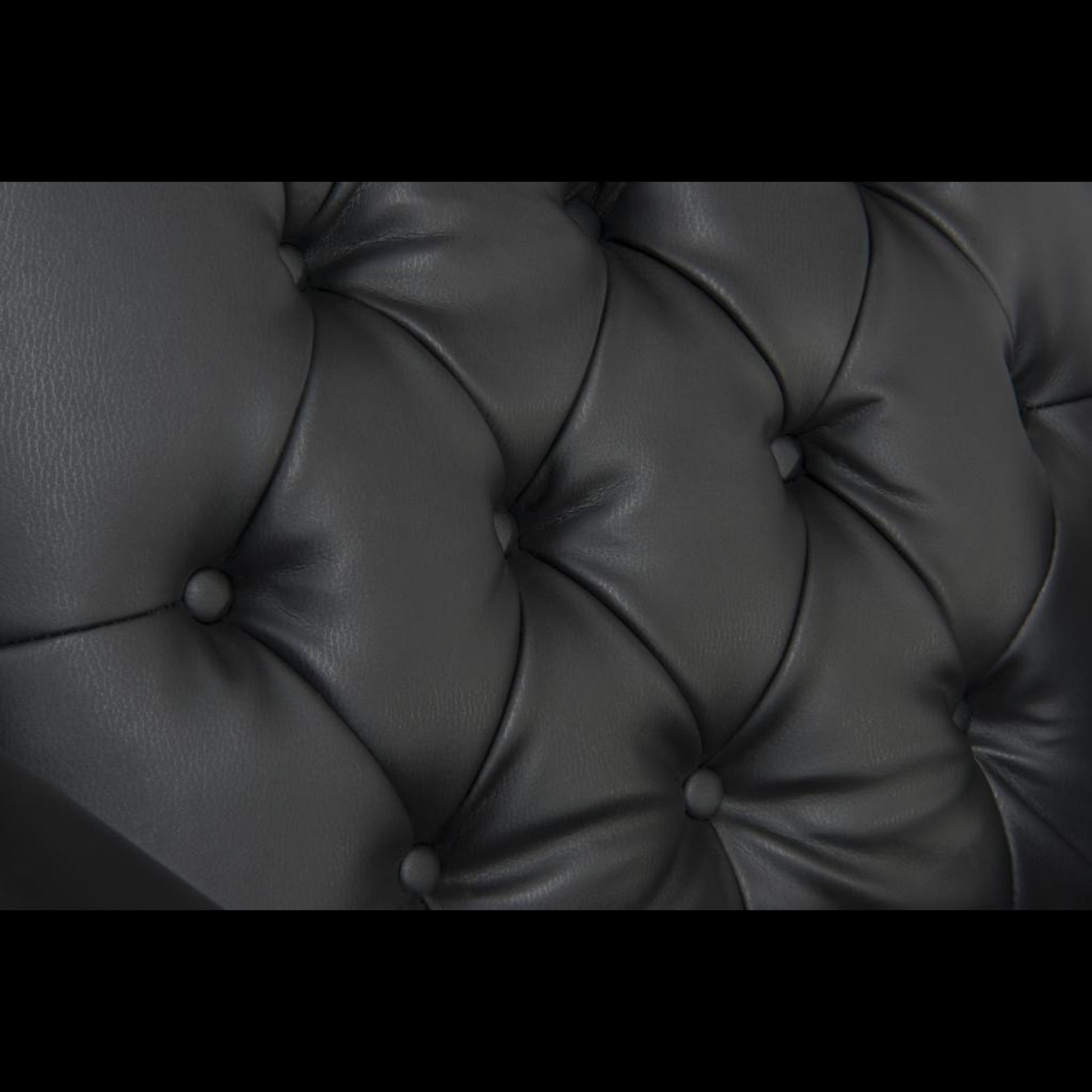 Close-up of a tufted black leather surface