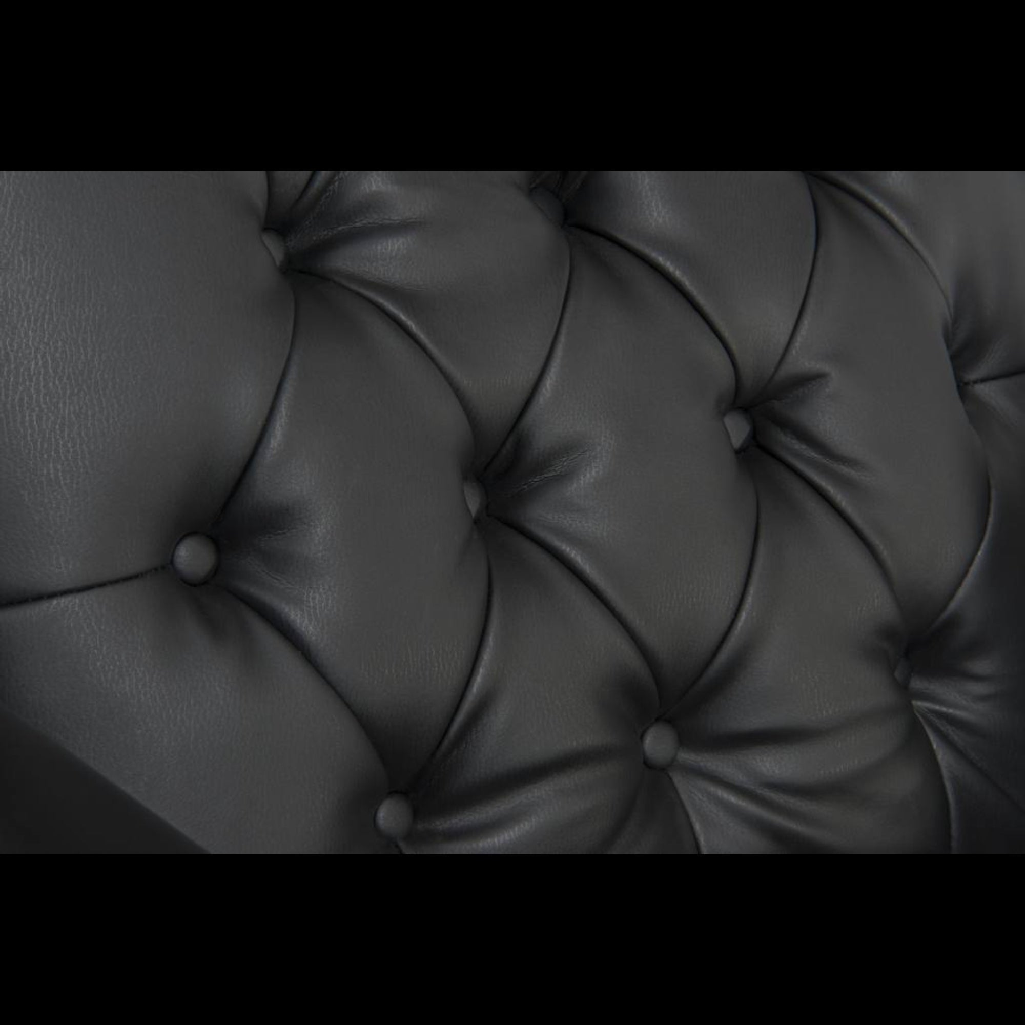 Close-up of a tufted black leather surface
