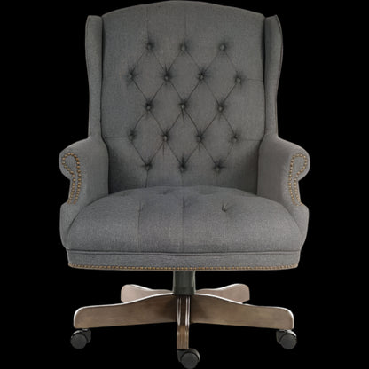 Gray tufted office chair with a black background