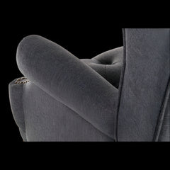Gray upholstered chair with tufted backrest on a black background