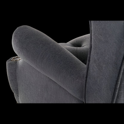 Gray upholstered chair with tufted backrest on a black background