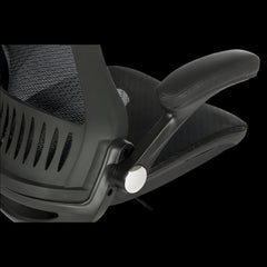 Close-up of a black office chair with mesh backrest on a black background