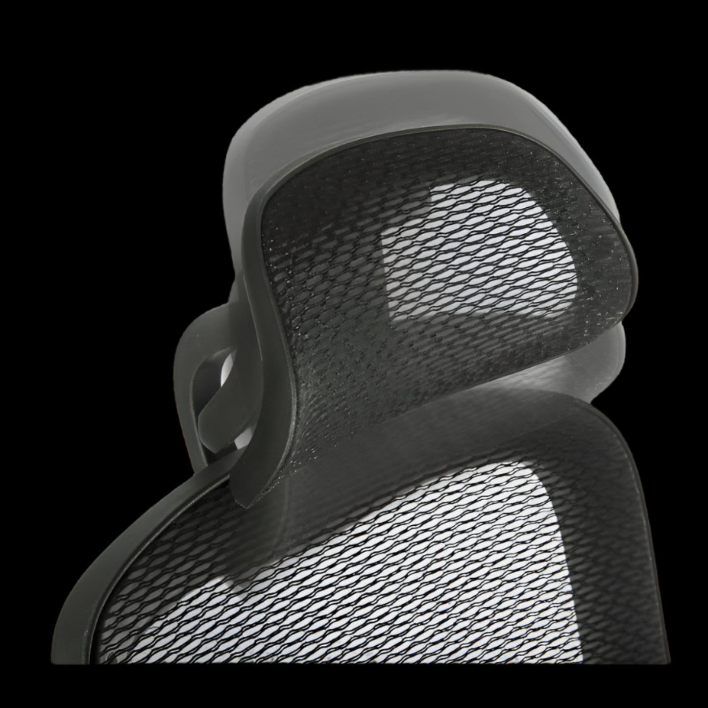 Close-up of a mesh office chair backrest on a black background