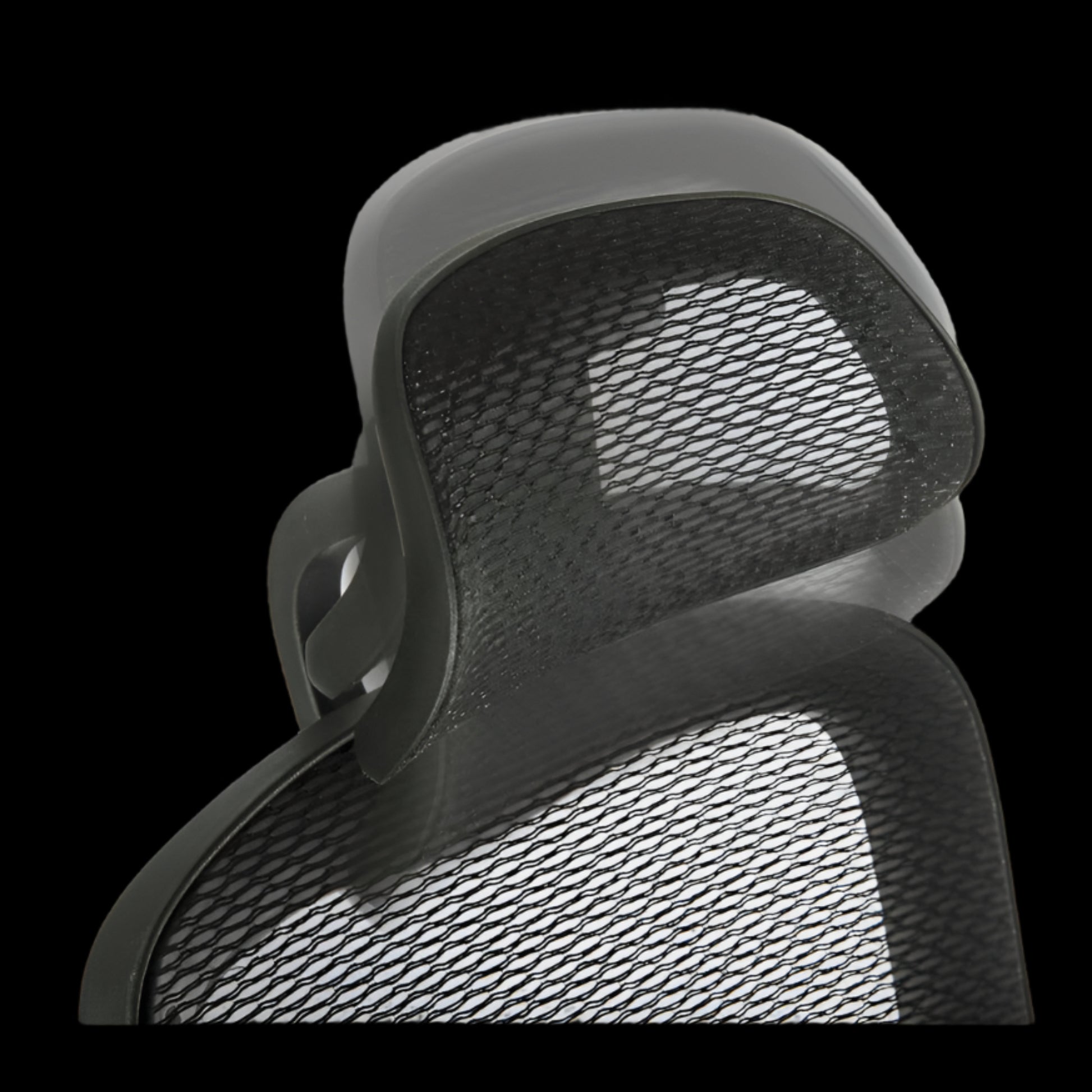 Close-up of a mesh office chair backrest on a black background