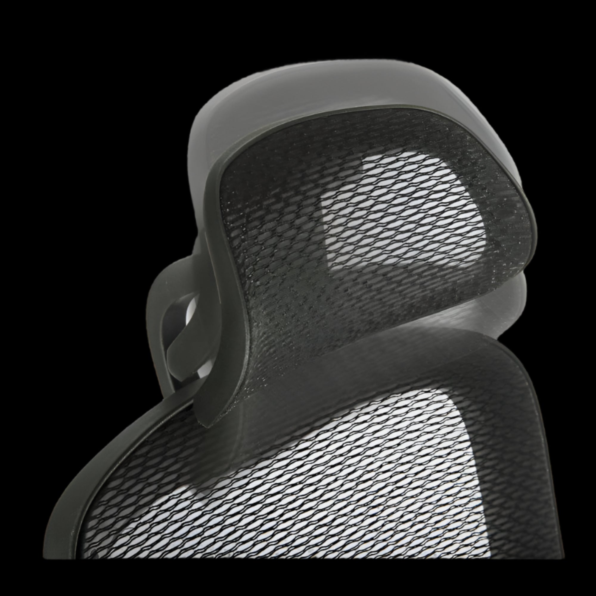 Close-up of a mesh office chair backrest on a black background