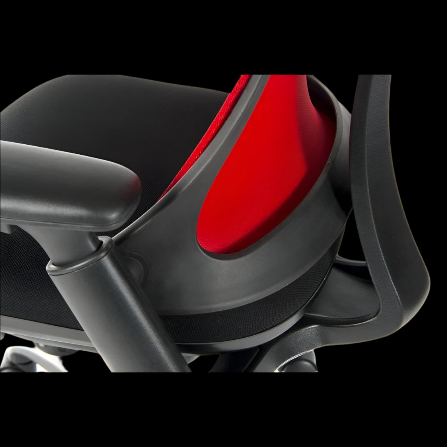 Close-up of an office chair seat with a red mesh back on a black background