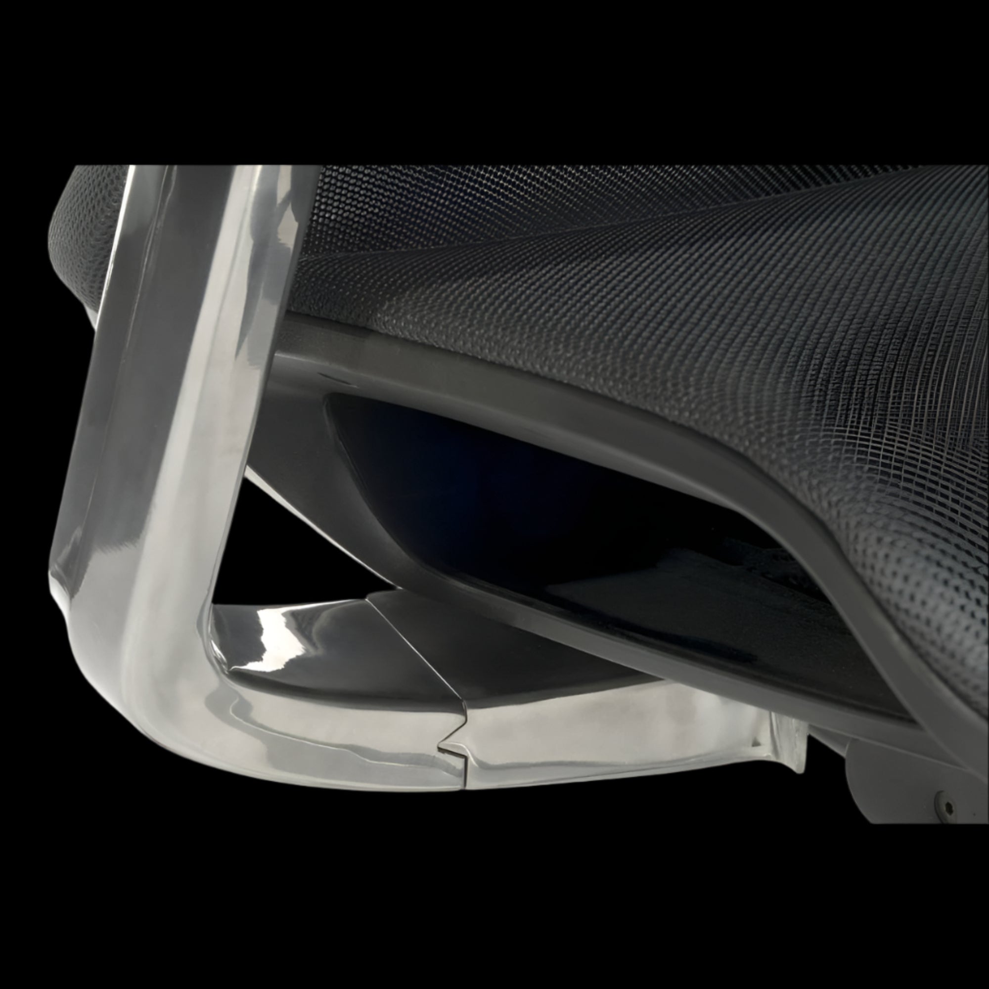 Close-up of a chair with a clear plastic cover on a black background