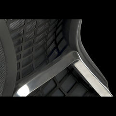 Close-up of a chair with mesh backrest and armrests on a black background