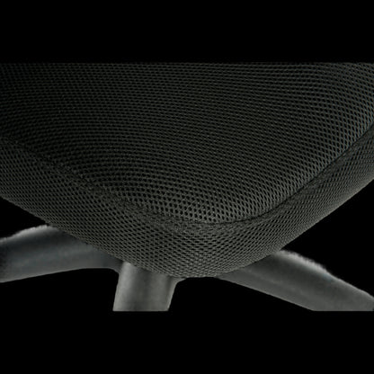 Close-up of a black office chair with mesh backrest on a black background