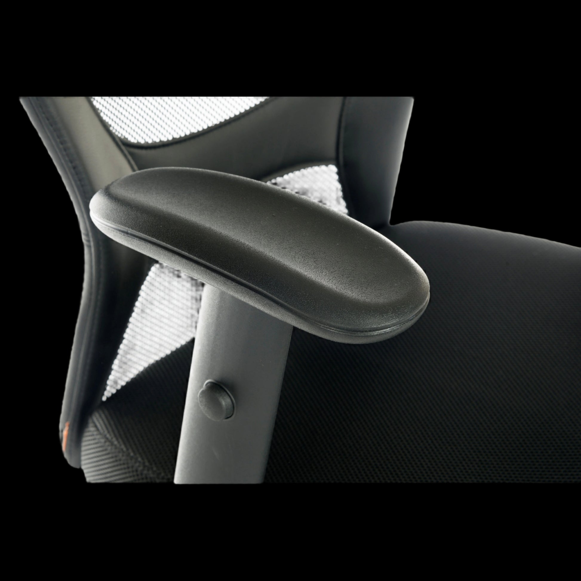 Close-up of an office chair armrest on a black background