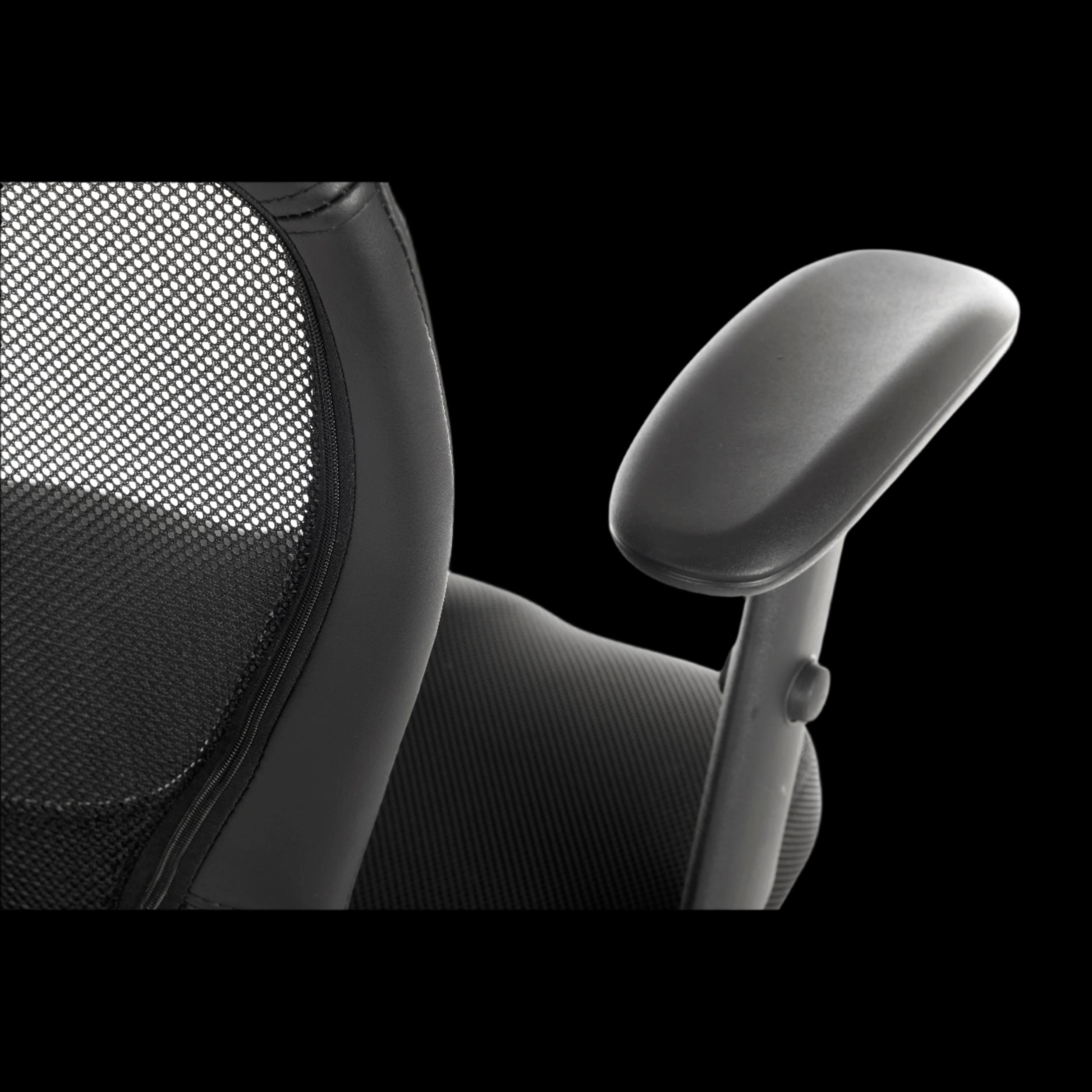 Close-up of an office chair with mesh backrest and armrest on a black background