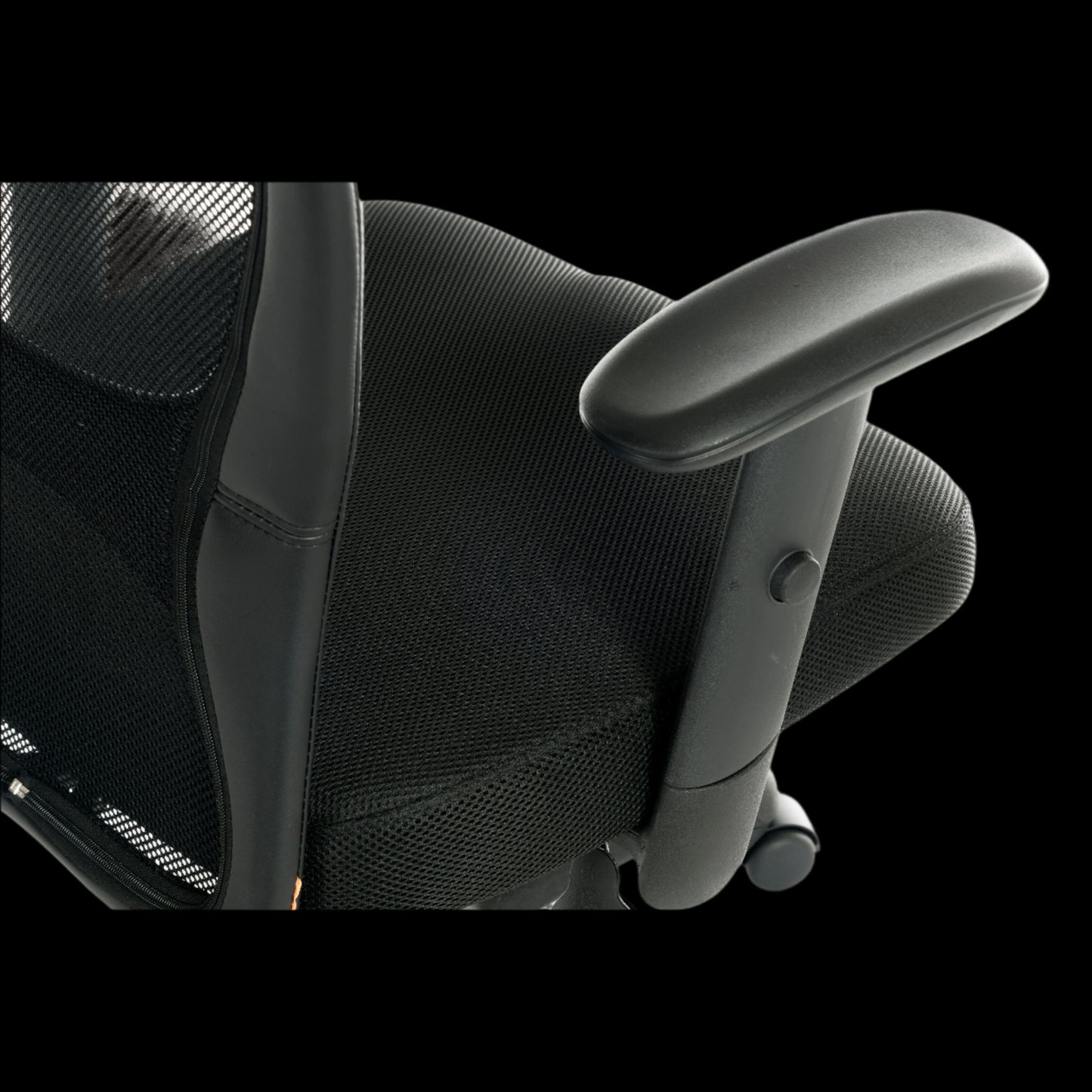 Black office chair with mesh backrest and armrests on a black background