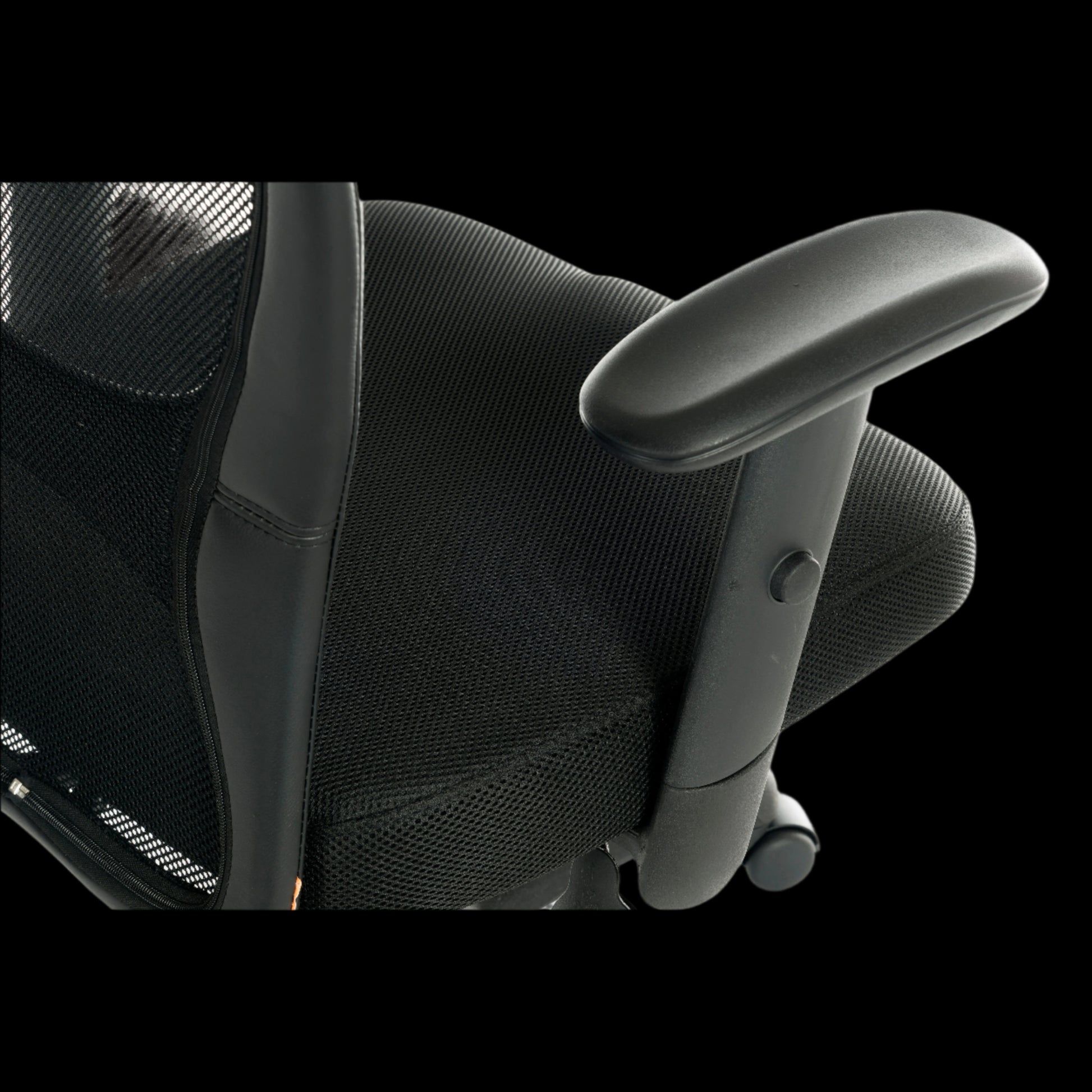 Black office chair with mesh backrest and armrests on a black background