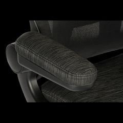Close-up of a textured armrest on an office chair with a black background