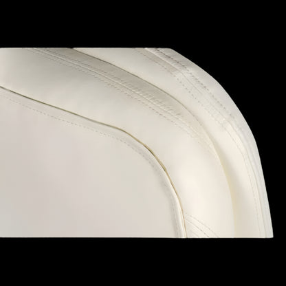 Close-up of a white car seat with visible stitching on a black background