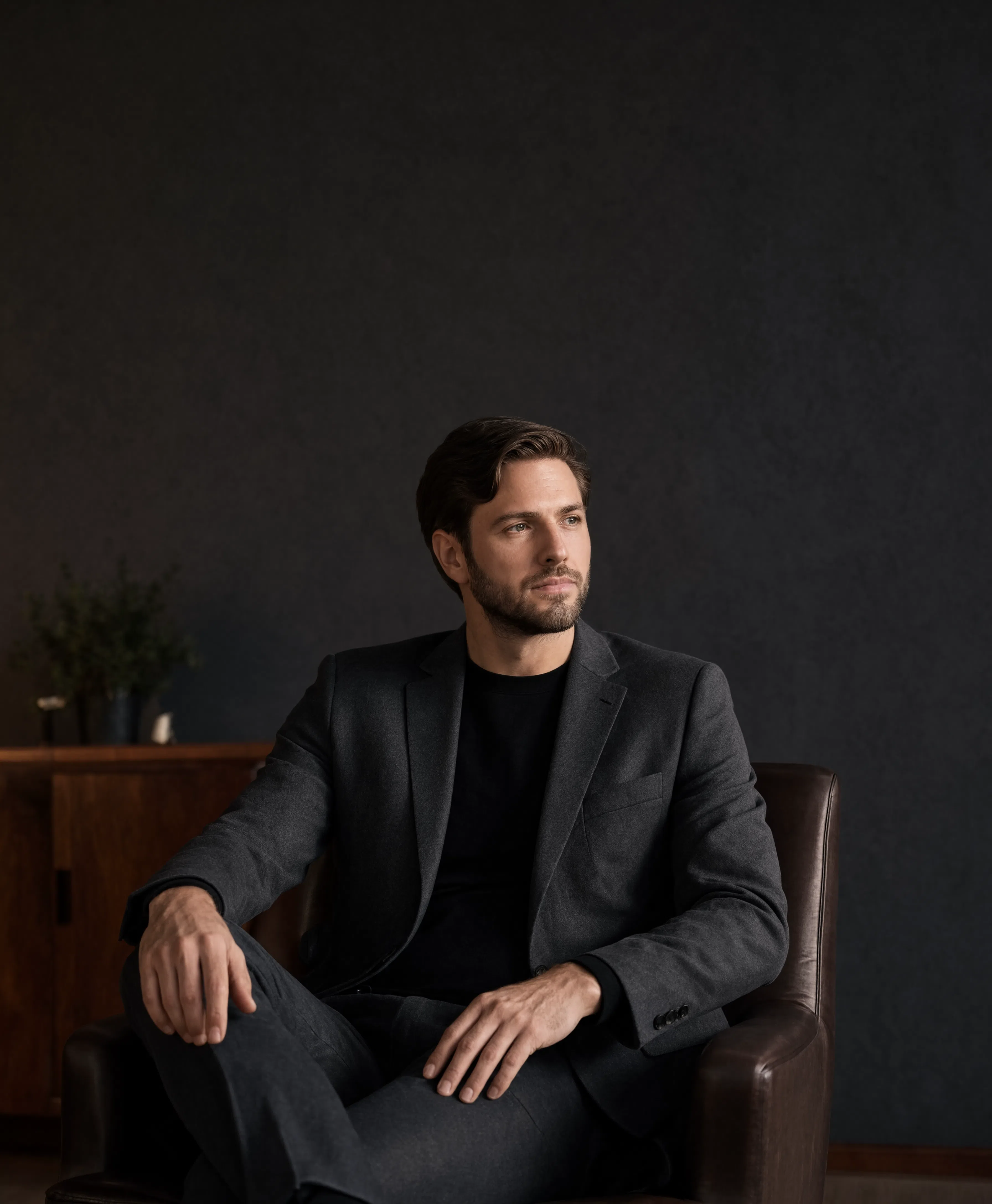Executive leather office chair in a dark home office — Apex Comfort