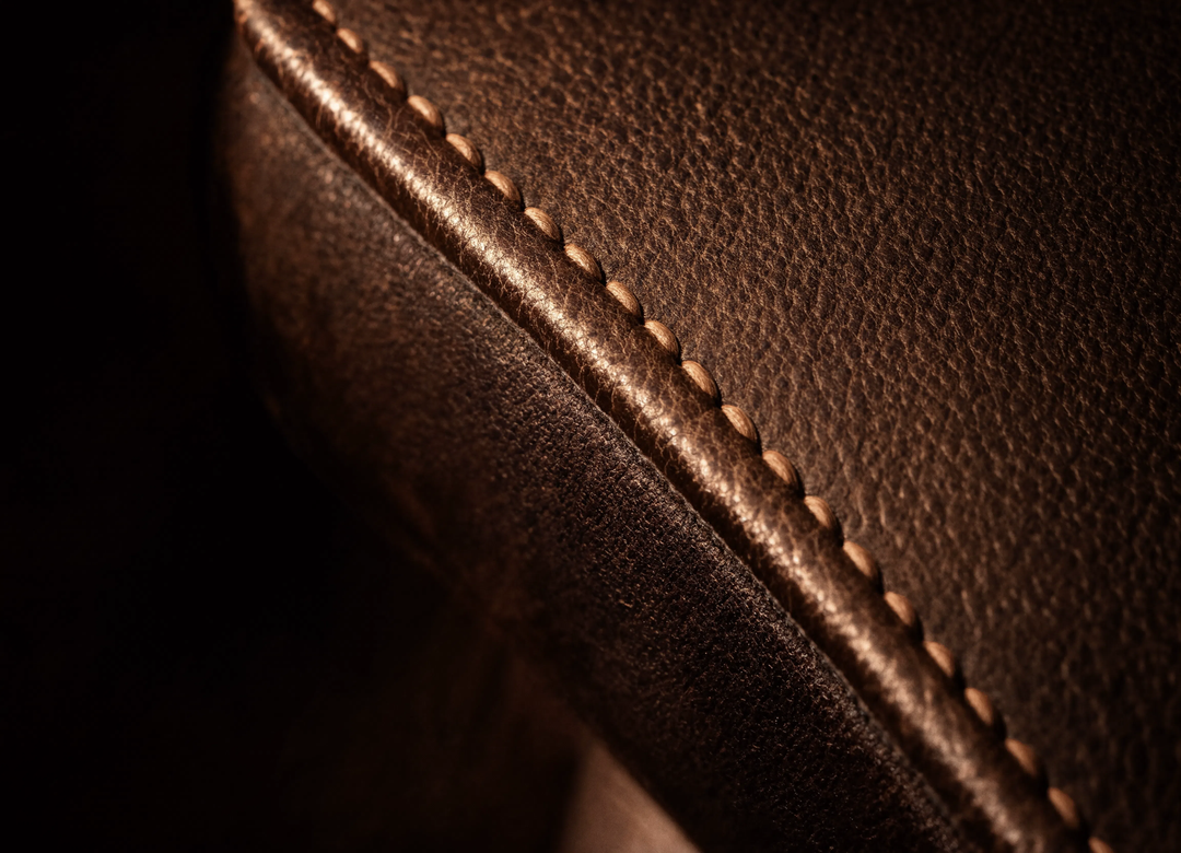 Close-up of stitched leather upholstery detail on an executive chair