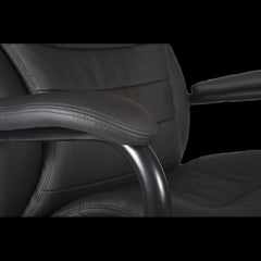 Close-up of a black office chair with armrests on a black background