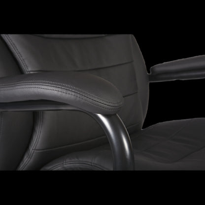 Close-up of a black office chair with armrests on a black background