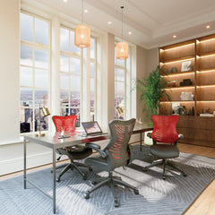 Modern office space with a desk, chairs, and large windows.