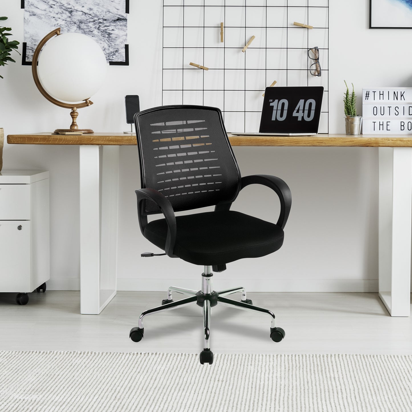 Black office chair in a modern office setting with a desk and decor.