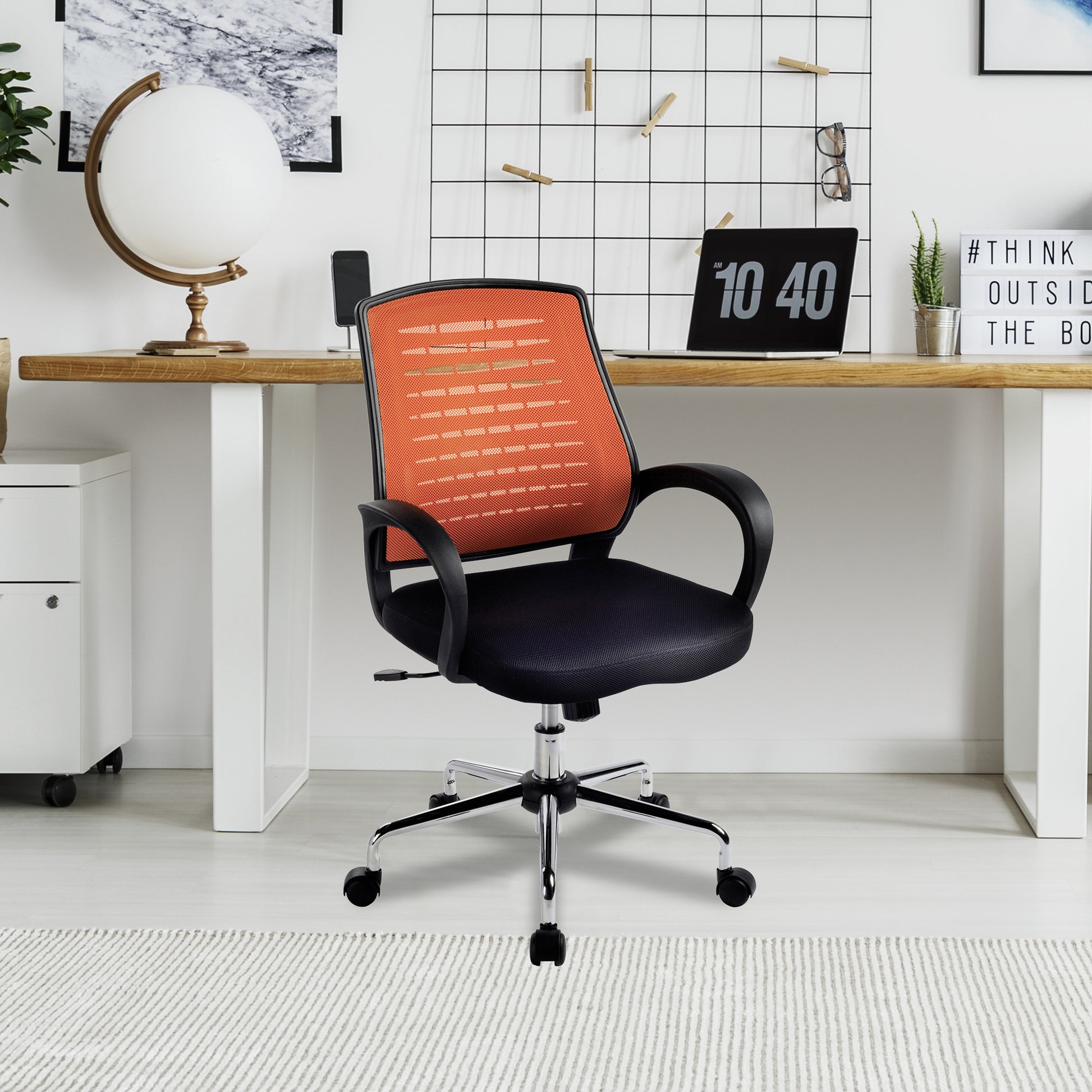 Black office chair with orange mesh backrest in a modern office setting