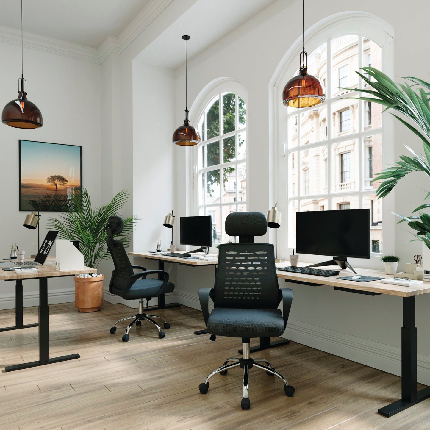 Modern office setup with ergonomic chairs, desks, and large windows.