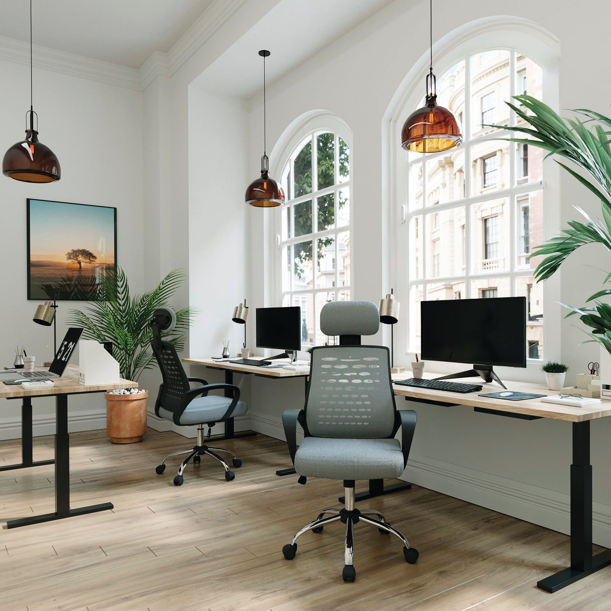 Modern office setup with ergonomic chair, desk, and computer monitors.