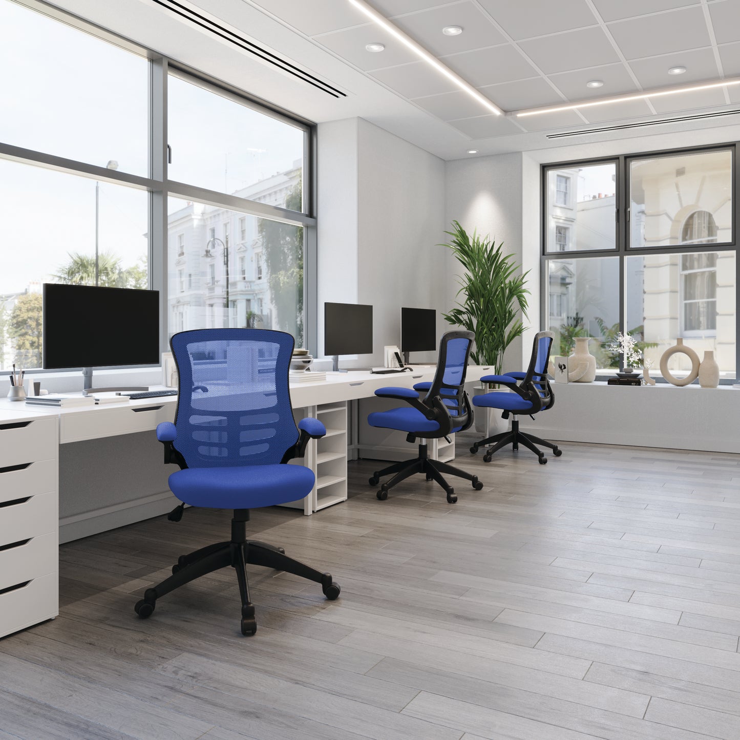 Modern office with blue chairs and white desks