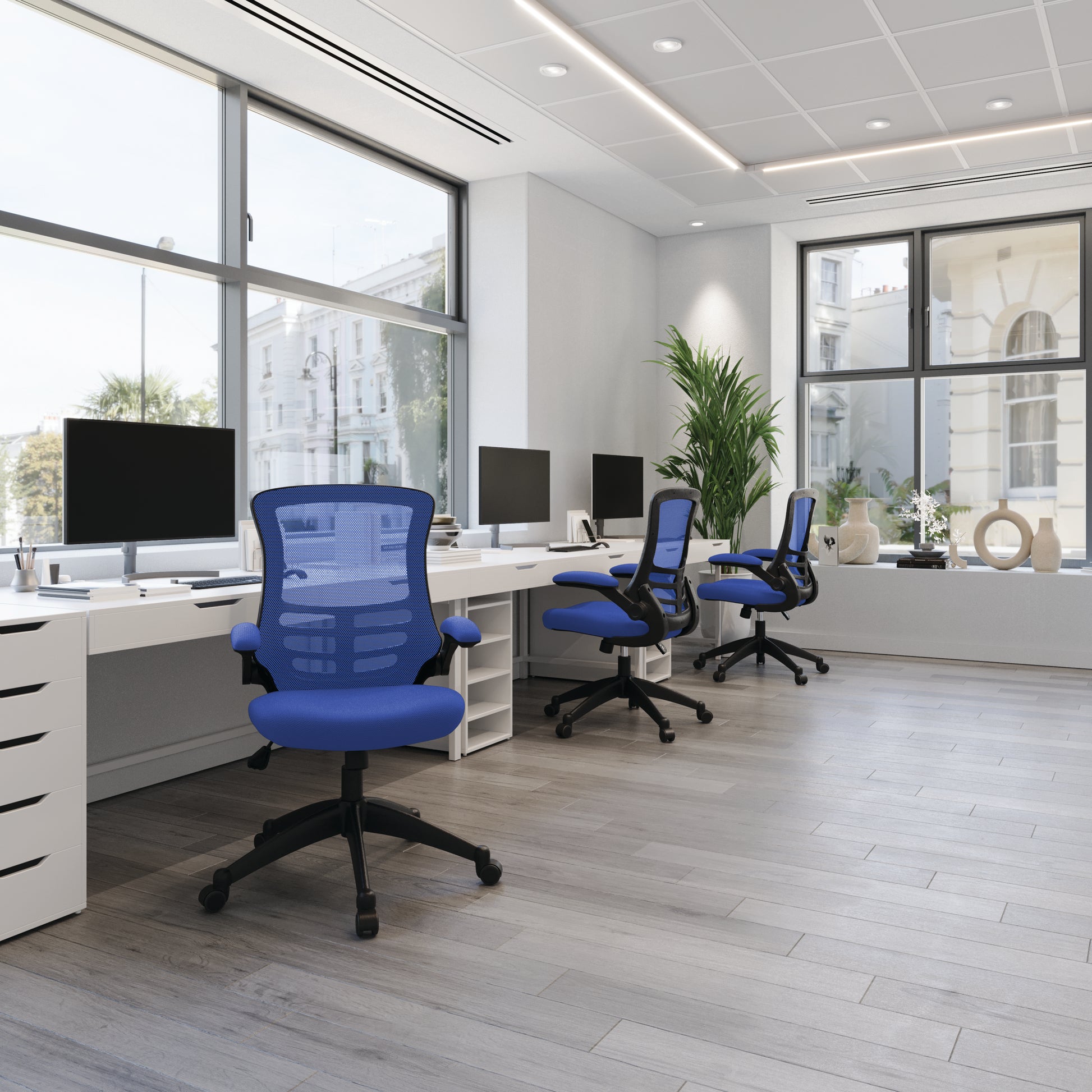 Modern office with blue chairs and white desks