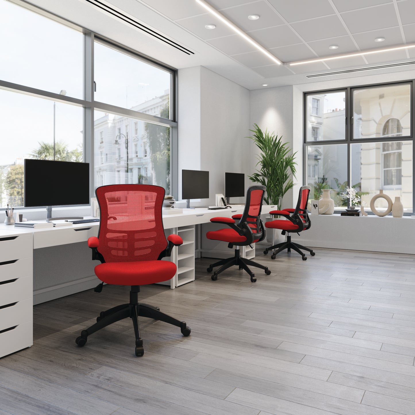 Modern office with red chairs and black desks