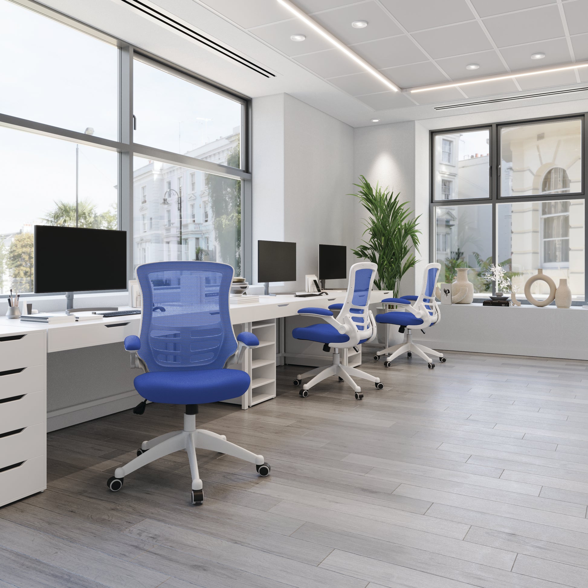 Modern office with blue chairs and white desks