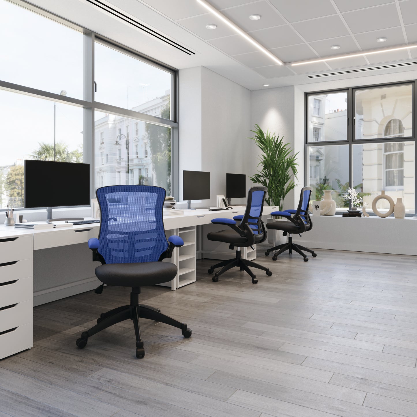 Modern office with desks, chairs, and large windows