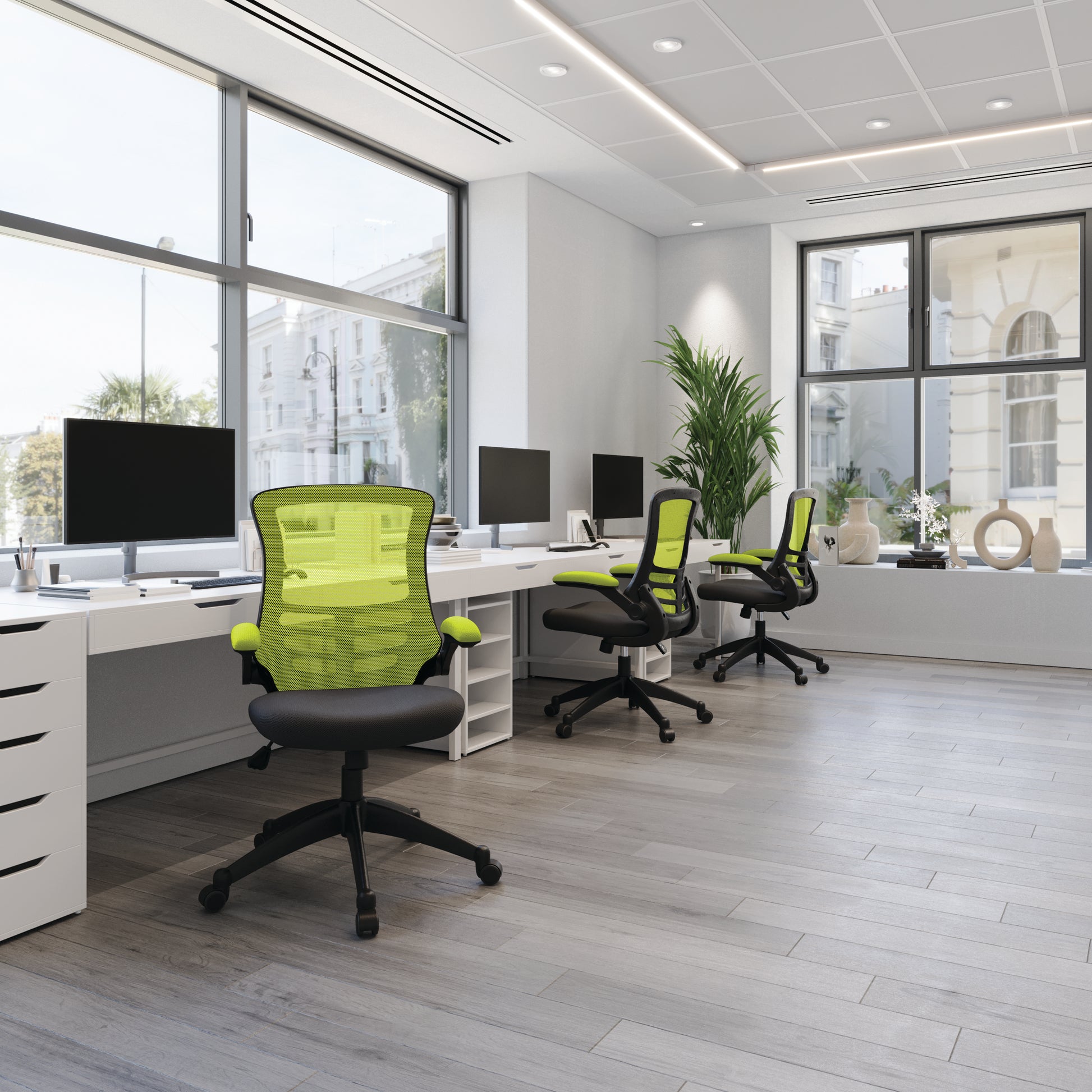 Modern office with green chairs and black desks