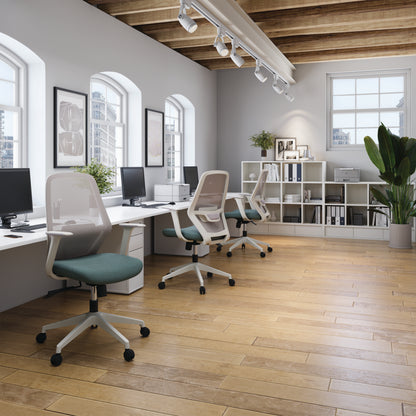 Modern office space with desks, chairs, and bookshelves.