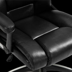 Close-up of a black office chair with leather seat and armrests on a black background