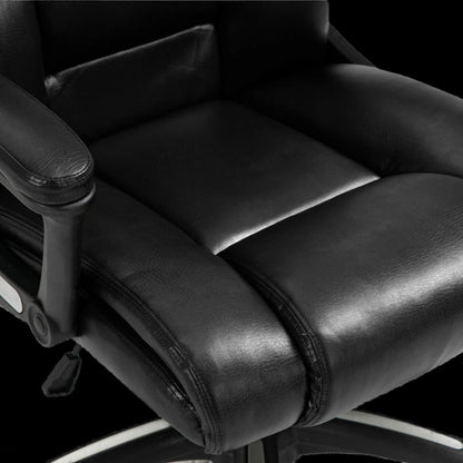 Close-up of a black office chair with leather seat and armrests on a black background