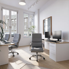 Modern office space with desks, chairs, and computer monitors.