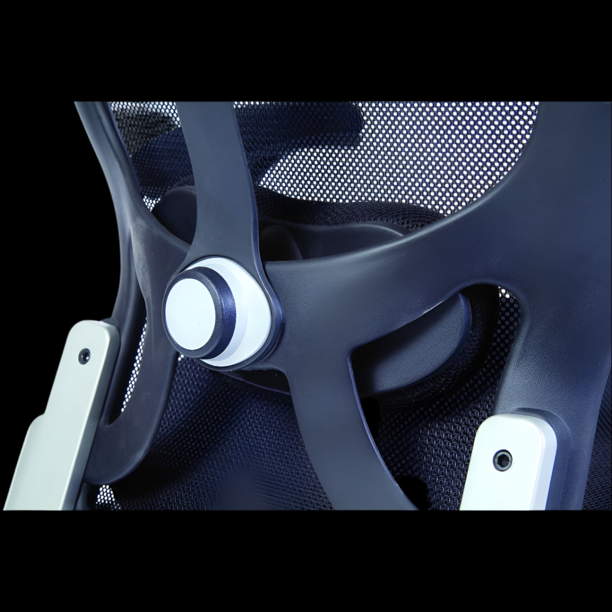 Close-up of a modern office chair with mesh backrest and dark frame.
