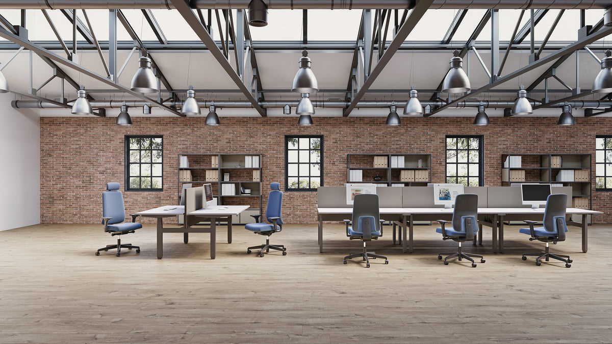 Prompt Task Chair at desks in an open-plan warehouse-style office